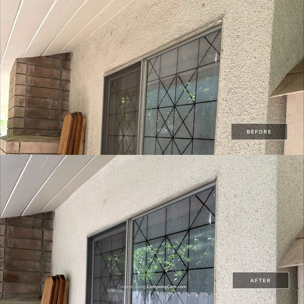 Stucco wall under eave before and after soft washing