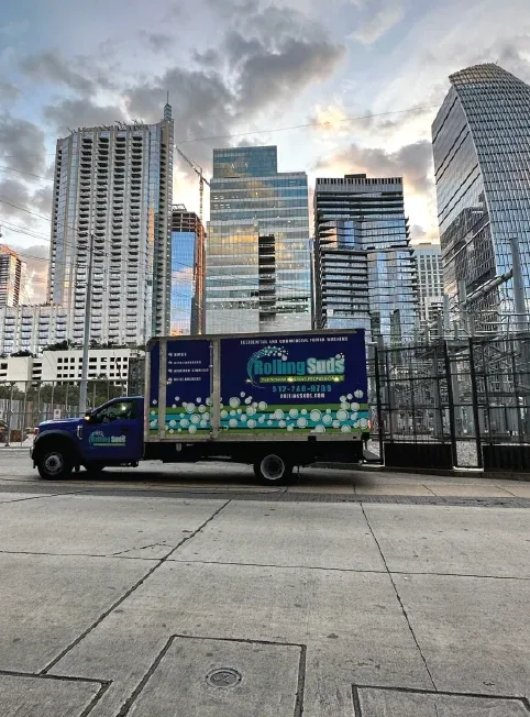 Company service truck beneath downtown high-rises